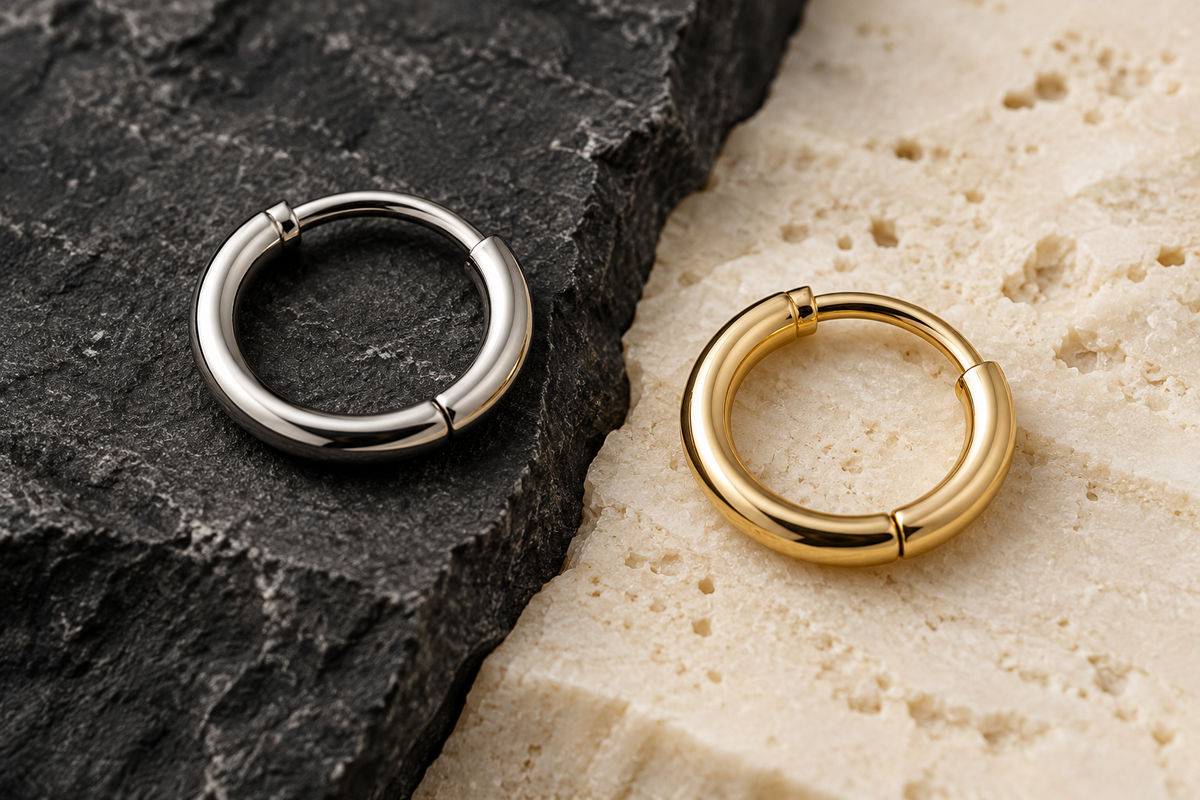Body jewelry materials and sizing details in a studio composition