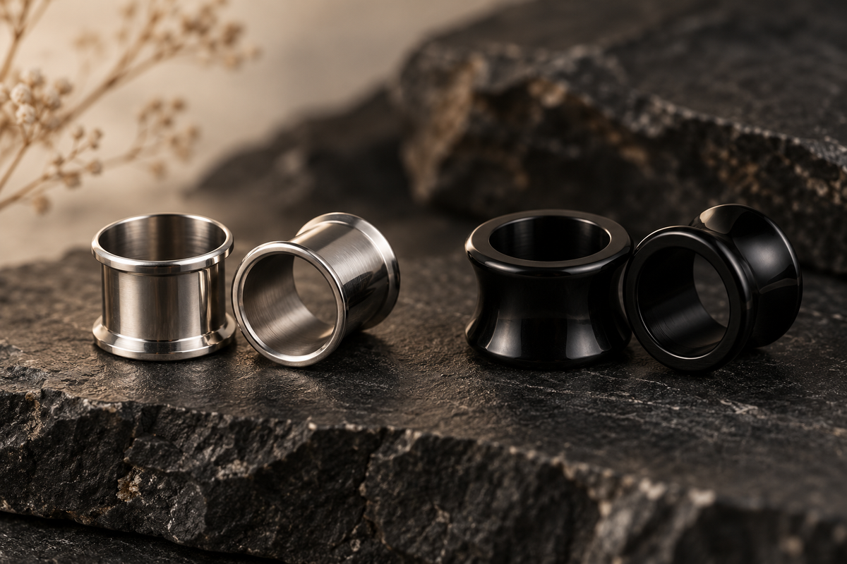 AI illustration of silver-tone and black flared ear jewelry on stone